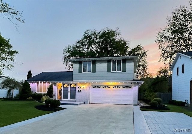 189 Culpepper Rd, Amherst, NY 14221 - split level home with concrete driveway, a yard, an attached garage, and brick siding