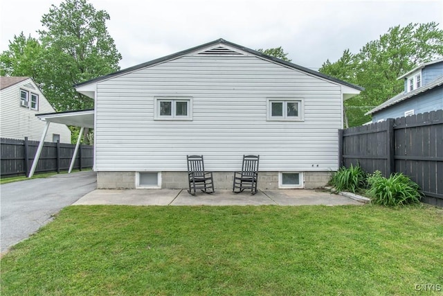 1039 Holcomb St, Watertown-City, NY 13601 - back of property featuring a patio area, a carport, and asphalt driveway