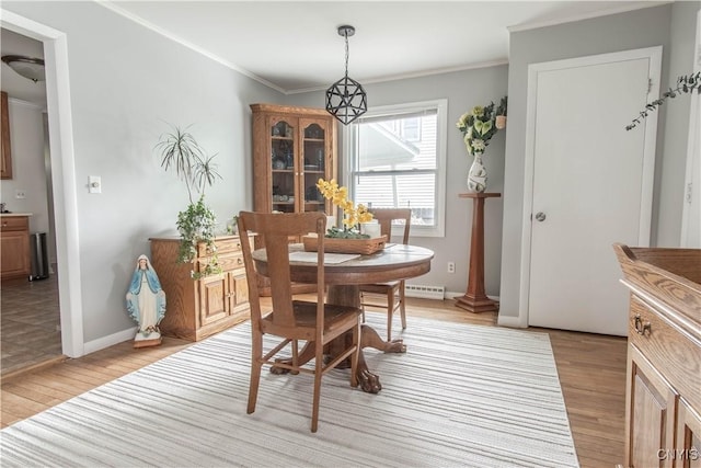1039 Holcomb St, Watertown-City, NY 13601 - dining space with light wood finished floors, baseboards, and crown molding