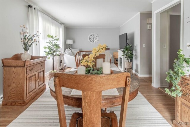 1039 Holcomb St, Watertown-City, NY 13601 - dining room featuring light wood-style floors, crown molding, and baseboards