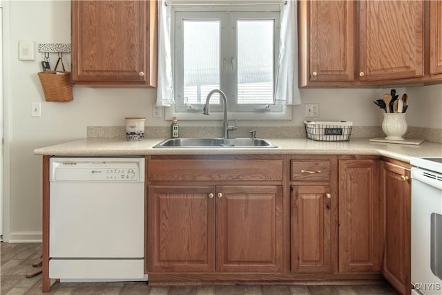 1039 Holcomb St, Watertown-City, NY 13601 - kitchen with dishwasher, a sink, light countertops, stove, and brown cabinets