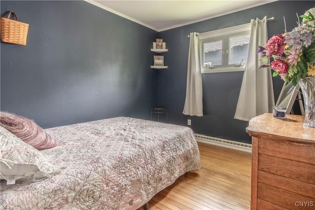 1039 Holcomb St, Watertown-City, NY 13601 - bedroom featuring a baseboard heating unit, wood finished floors, crown molding, and baseboards