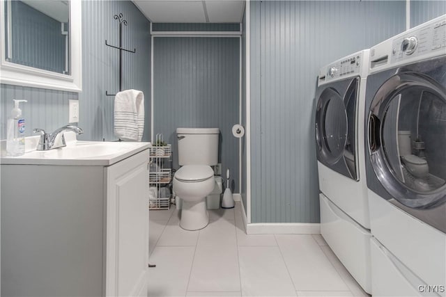1039 Holcomb St, Watertown-City, NY 13601 - bathroom featuring independent washer and dryer, vanity, toilet, tile patterned flooring, and baseboards