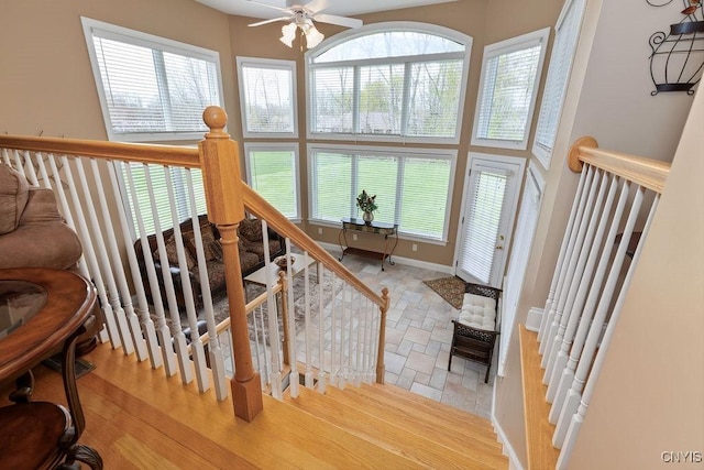 1968 Penfold Way, Lysander, NY 13027 - stairway featuring a ceiling fan, healthy amount of natural light, wood finished floors, and baseboards