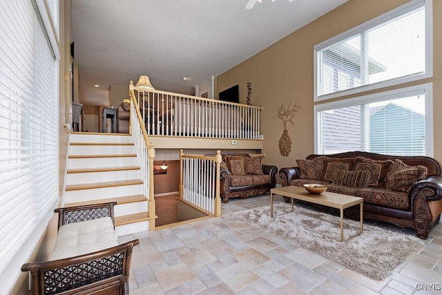 1968 Penfold Way, Lysander, NY 13027 - living room with stone tile floors, stairs, and baseboards