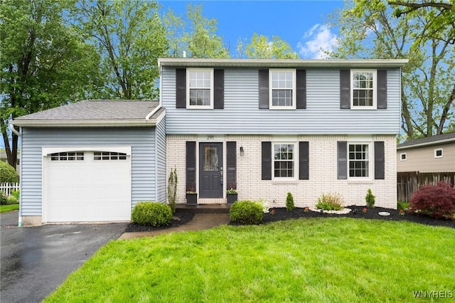 291 W Klein Rd, Amherst, NY 14221 - colonial house with a garage, driveway, a front yard, and brick siding