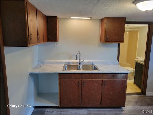 8723 E Mud Lake Rd, Lysander, NY 13027 - kitchen featuring a sink, wood finished floors, and a textured ceiling