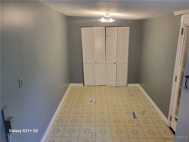8723 E Mud Lake Rd, Lysander, NY 13027 - unfurnished bedroom featuring baseboards, light flooring, and a closet