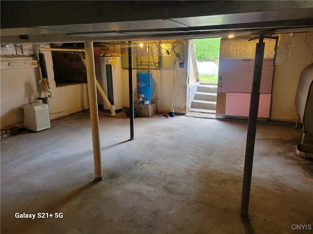 8723 E Mud Lake Rd, Lysander, NY 13027 - basement featuring a water pressure tank, water heater, and stairway
