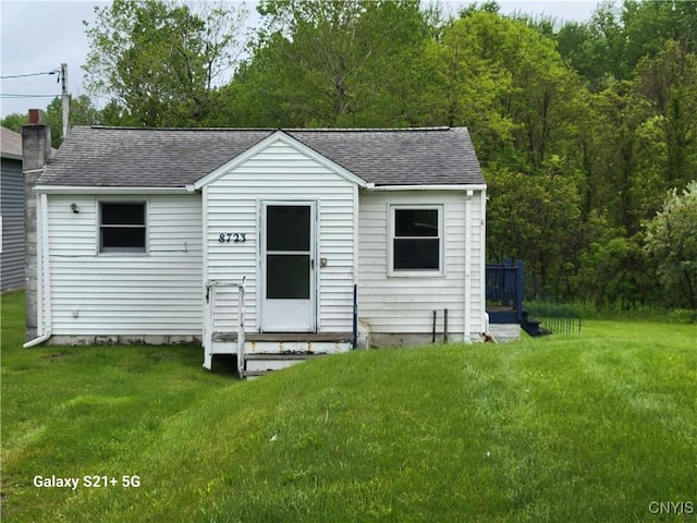 8723 E Mud Lake Rd, Lysander, NY 13027 - rear view of house featuring roof with shingles, a yard, and entry steps