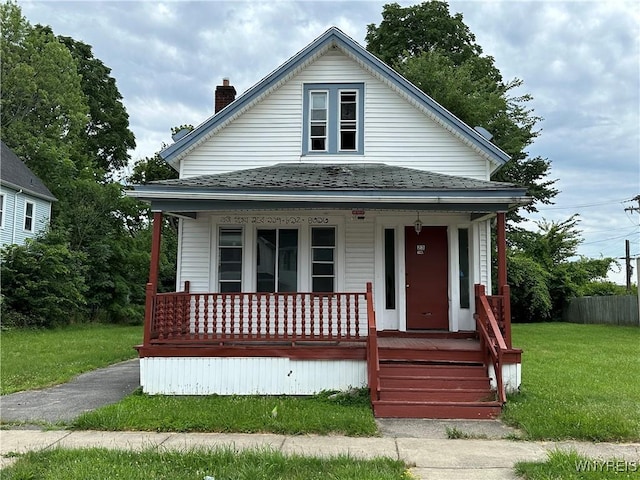 23 Cayuga St, Buffalo, NY 14211 - view of front of property featuring a porch, a front lawn, a chimney, and a shingled roof