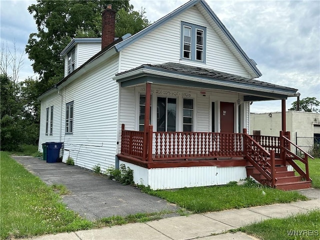 23 Cayuga St, Buffalo, NY 14211 - view of front of house featuring covered porch, a chimney, and a shingled roof