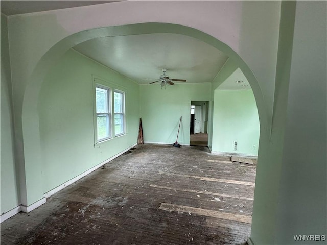 23 Cayuga St, Buffalo, NY 14211 - unfurnished living room with arched walkways, a ceiling fan, hardwood / wood-style flooring, and baseboards