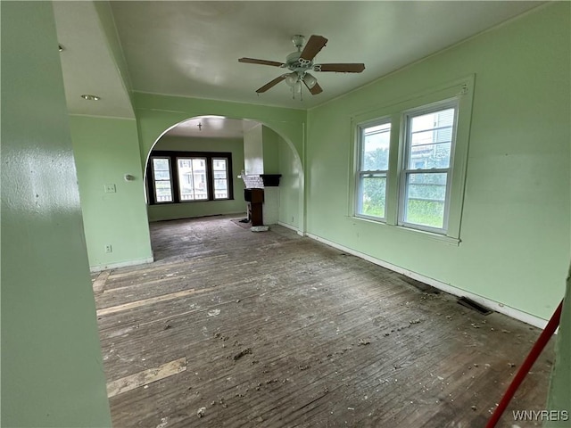 23 Cayuga St, Buffalo, NY 14211 - unfurnished living room featuring arched walkways, a ceiling fan, hardwood / wood-style flooring, and baseboards