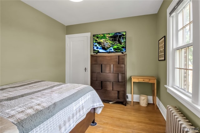 88 Garland Dr, Amherst, NY 14226 - bedroom featuring radiator, light wood-style flooring, and baseboards
