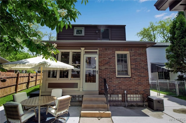 88 Garland Dr, Amherst, NY 14226 - rear view of house with brick siding, a patio area, outdoor dining area, and entry steps