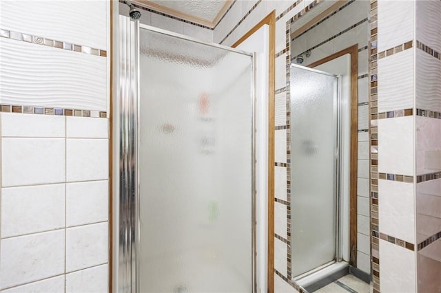 7425 Eelpot Rd, Naples, NY 14512 - bathroom with a shower stall, tile walls, and tile patterned flooring