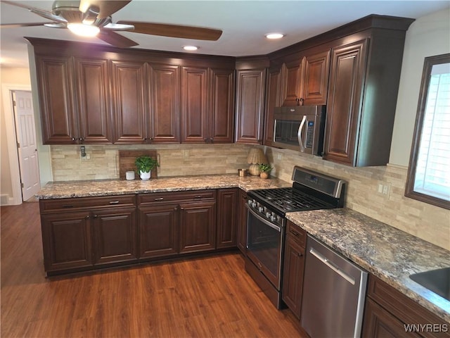 3508 Warner Dr, Grand Island, NY 14072 - kitchen with stainless steel appliances, ceiling fan, light stone countertops, dark wood-style floors, and decorative backsplash