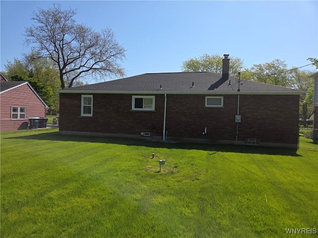 3508 Warner Dr, Grand Island, NY 14072 - back of property with brick siding, a lawn, a chimney, and a shingled roof