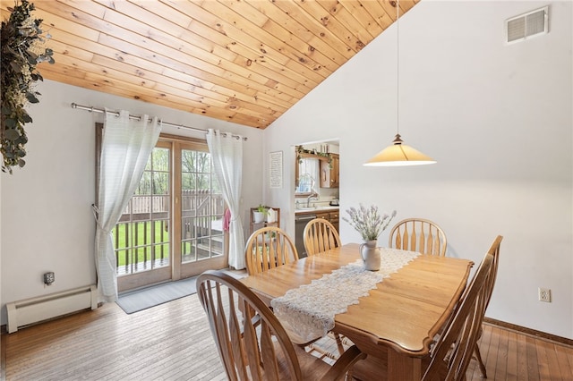 101 Winchell Rd, Owego, NY 13827 - dining space featuring baseboard heating, wood-type flooring, wood ceiling, baseboards, and high vaulted ceiling