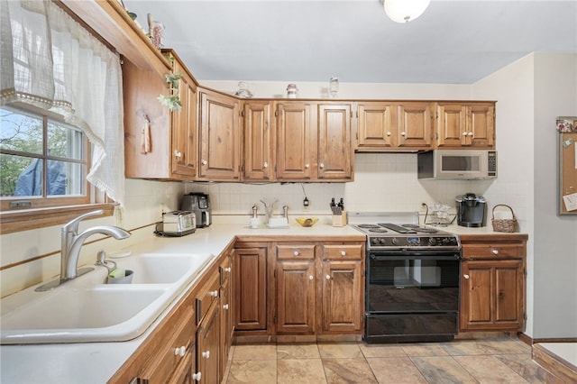 101 Winchell Rd, Owego, NY 13827 - kitchen with black range with electric cooktop, a sink, white microwave, and backsplash