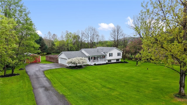 101 Winchell Rd, Owego, NY 13827 - tri-level home with a porch, a front lawn, asphalt driveway, and an attached garage