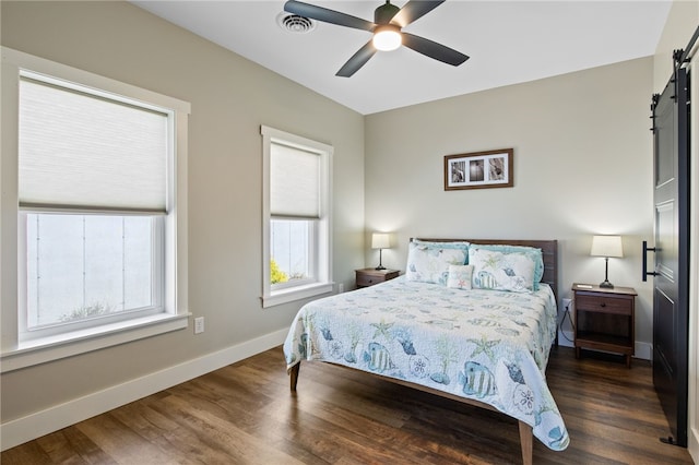 8419 Old Lake Rd, Lodi, NY 14860 - bedroom featuring a barn door, wood finished floors, baseboards, and a ceiling fan