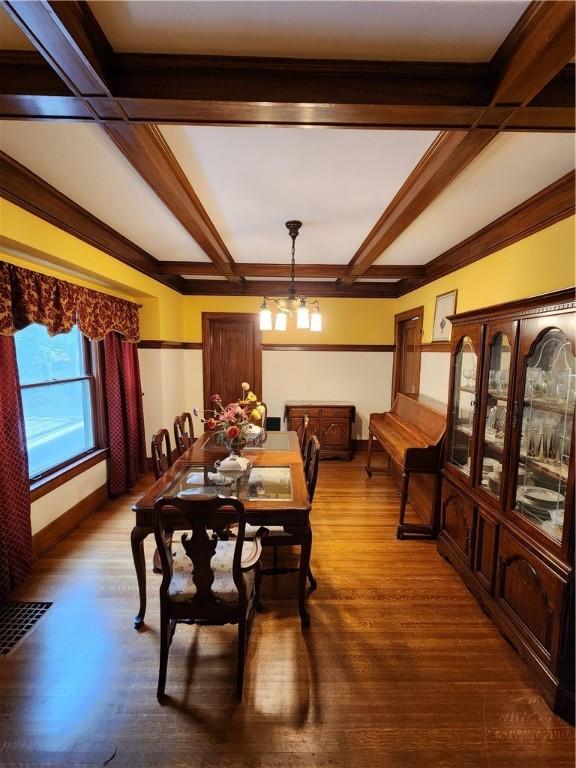 83 Vermont St, Rochester, NY 14609 - dining room with wood finished floors, a chandelier, beamed ceiling, and baseboards