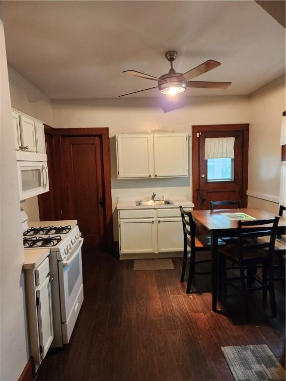 83 Vermont St, Rochester, NY 14609 - kitchen with white appliances, a sink, ceiling fan, light countertops, and dark wood-style flooring