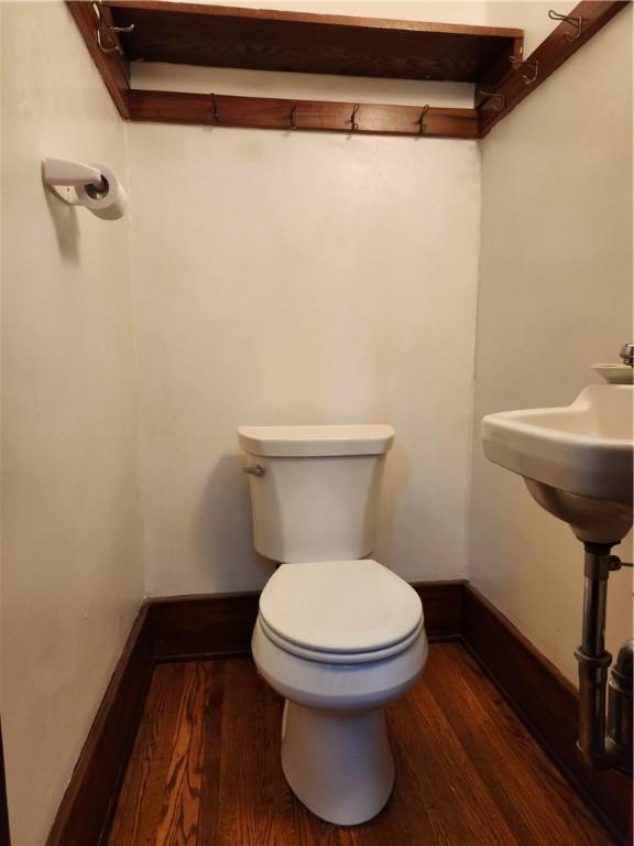 83 Vermont St, Rochester, NY 14609 - bathroom with wood finished floors, toilet, and baseboards