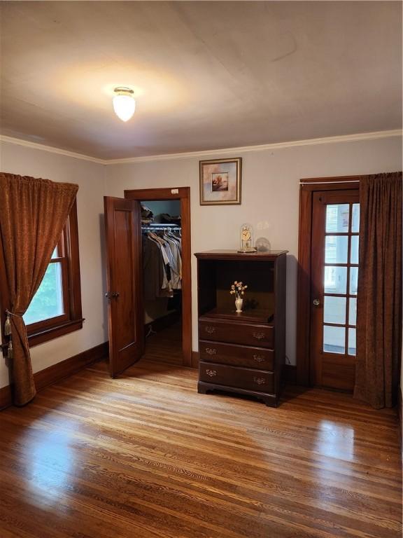 83 Vermont St, Rochester, NY 14609 - bedroom with wood finished floors, multiple windows, baseboards, and crown molding