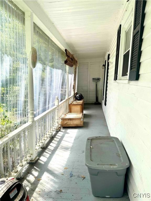 4 S St, Belfast, NY 14711 - unfurnished sunroom featuring plenty of natural light and hardwood / wood-style flooring