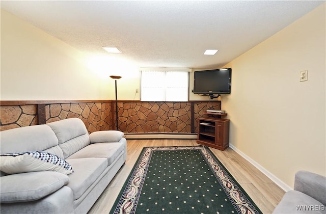 704 Beach Rd, Evans, NY 14006 - living room with light wood-type flooring and baseboard heating