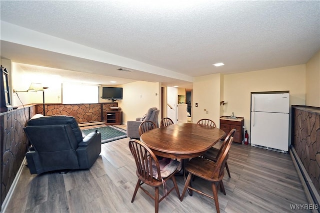 704 Beach Rd, Evans, NY 14006 - dining area with wood finished floors and a textured ceiling