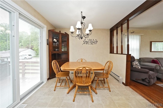 704 Beach Rd, Evans, NY 14006 - dining area featuring a baseboard radiator and a chandelier