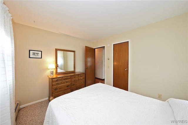 704 Beach Rd, Evans, NY 14006 - carpeted bedroom with baseboards, a baseboard heating unit, and multiple closets