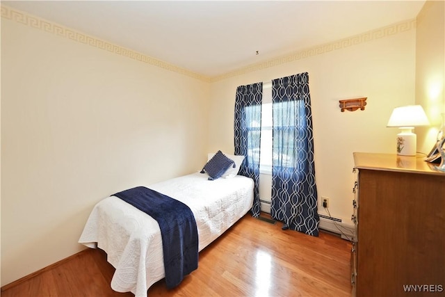 704 Beach Rd, Evans, NY 14006 - bedroom with wood finished floors, baseboard heating, and baseboards