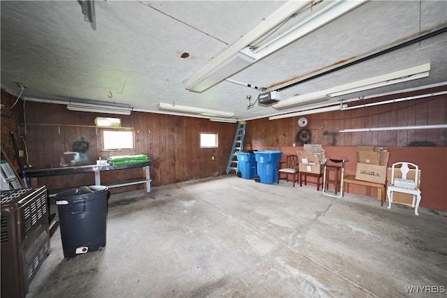 704 Beach Rd, Evans, NY 14006 - garage featuring a garage door opener and wood walls