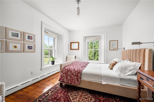 9940 Middle Rd, Pulteney, NY 14840 - bedroom featuring baseboard heating, multiple windows, and hardwood / wood-style flooring