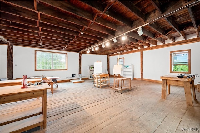 9940 Middle Rd, Pulteney, NY 14840 - basement with rail lighting, hardwood / wood-style flooring, healthy amount of natural light, and baseboards