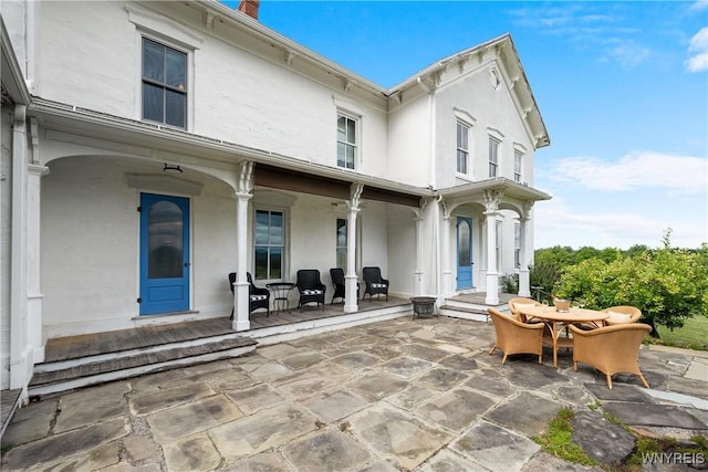 9940 Middle Rd, Pulteney, NY 14840 - back of house featuring stucco siding, outdoor dining area, and a patio area