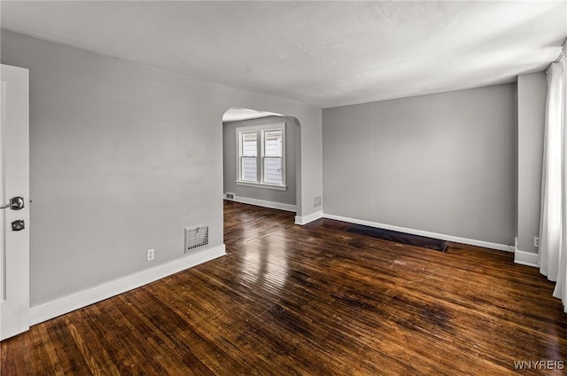374 Victoria Blvd, Tonawanda-Town, NY 14217 - empty room featuring arched walkways, baseboards, and wood finished floors