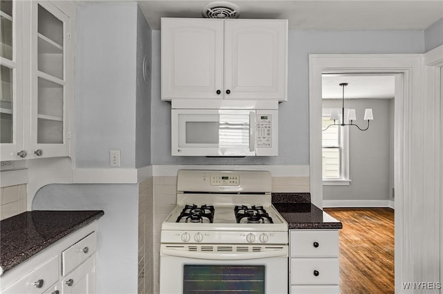 374 Victoria Blvd, Tonawanda-Town, NY 14217 - kitchen featuring white appliances, a chandelier, white cabinetry, and glass insert cabinets