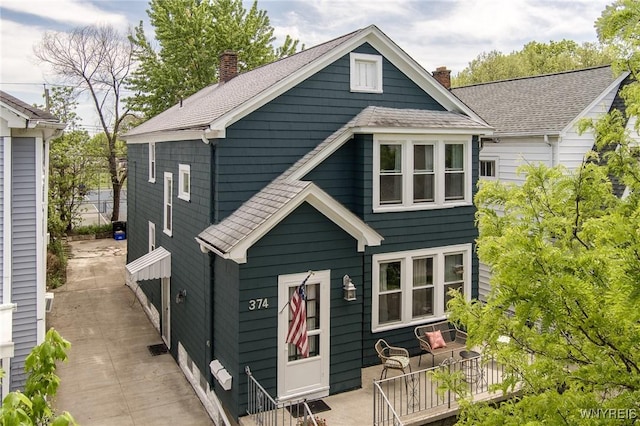 374 Victoria Blvd, Tonawanda-Town, NY 14217 - back of house featuring a chimney, a shingled roof, and a wooden deck