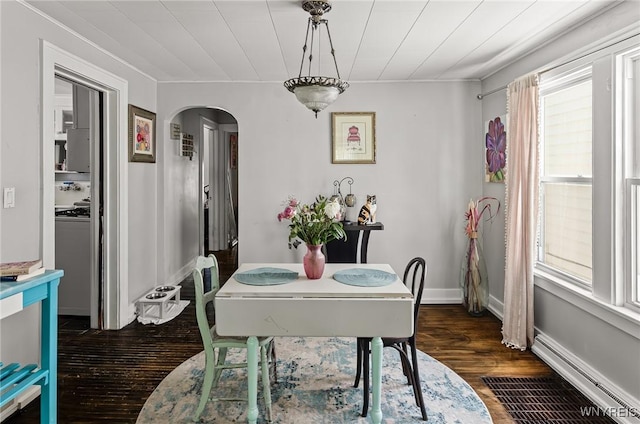 374 Victoria Blvd, Tonawanda-Town, NY 14217 - dining room featuring arched walkways, dark wood finished floors, a baseboard radiator, and baseboards