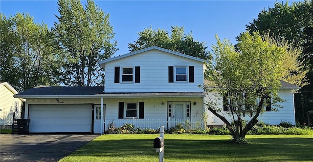 11 Donna Marie Cir, Gates, NY 14606 - traditional home with a garage, a porch, asphalt driveway, and a front lawn