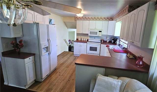 11 Donna Marie Cir, Gates, NY 14606 - kitchen featuring white appliances, light wood-style floors, dark countertops, and white cabinetry