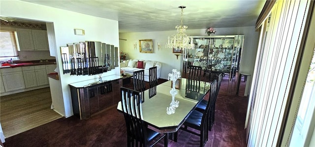 11 Donna Marie Cir, Gates, NY 14606 - dining area featuring a chandelier and dark carpet