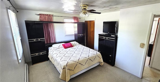 11 Donna Marie Cir, Gates, NY 14606 - bedroom featuring light carpet, baseboard heating, and a ceiling fan