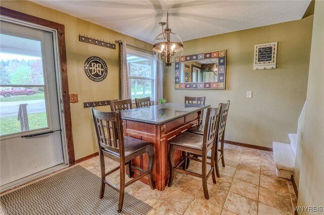 26 Pine Tree Village Rd Unit 26, Ellicottville, NY 14731 - dining area with a chandelier and baseboards